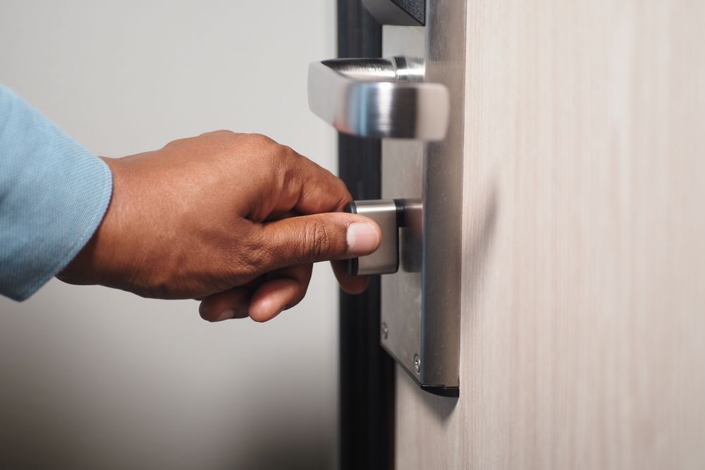 Parent securing a smart door lock at home