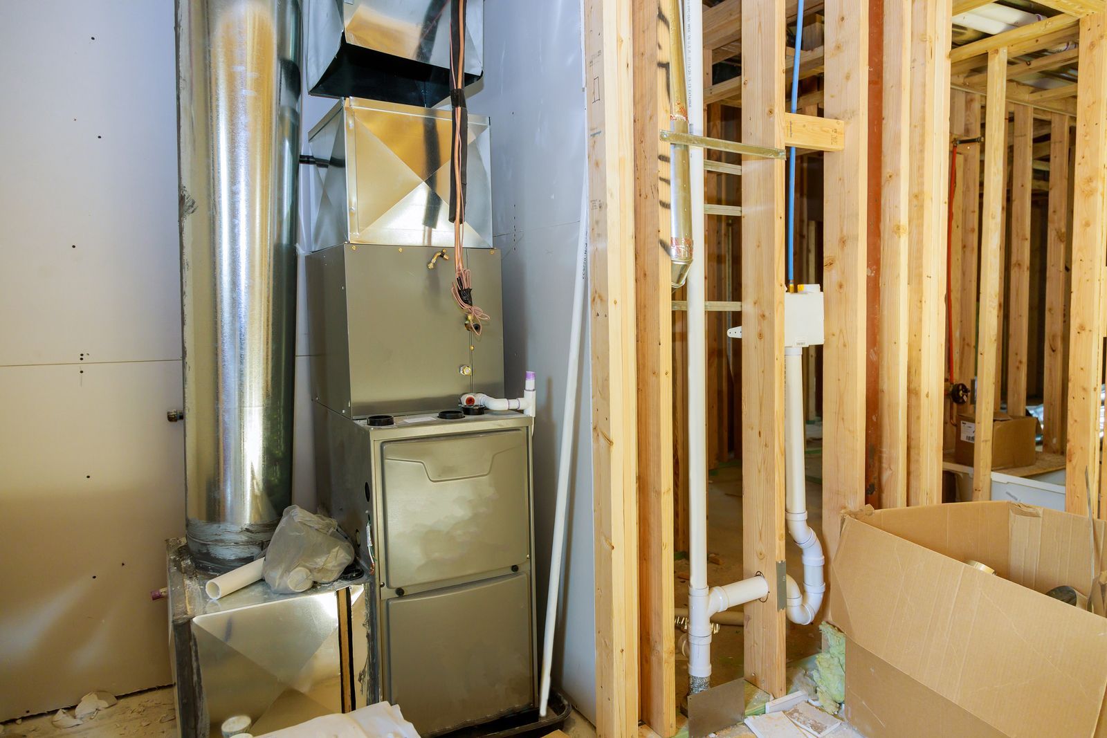 An air conditioner is sitting in a room under construction