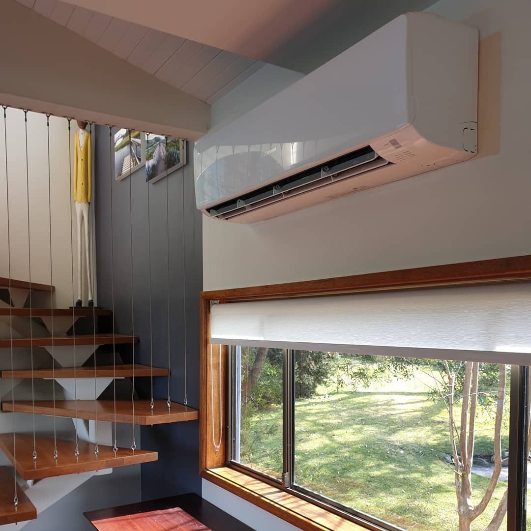 White Air Conditioning Unit Mounted on A Wall — Bay & Basin Air Conditioning & Refrigeration Pty Ltd in St Georges Basin, NSW