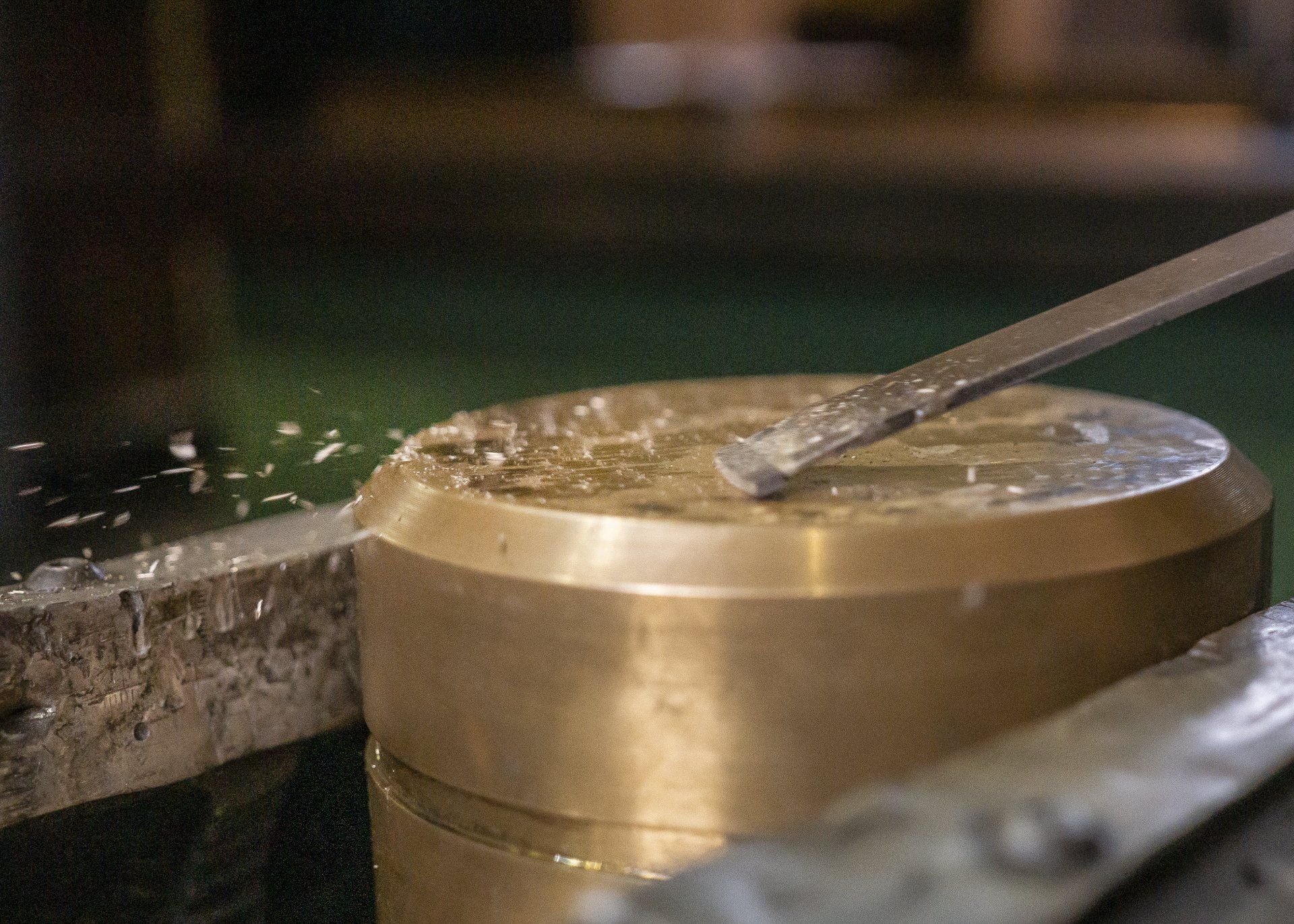 A person is cutting a piece of metal with a machine.