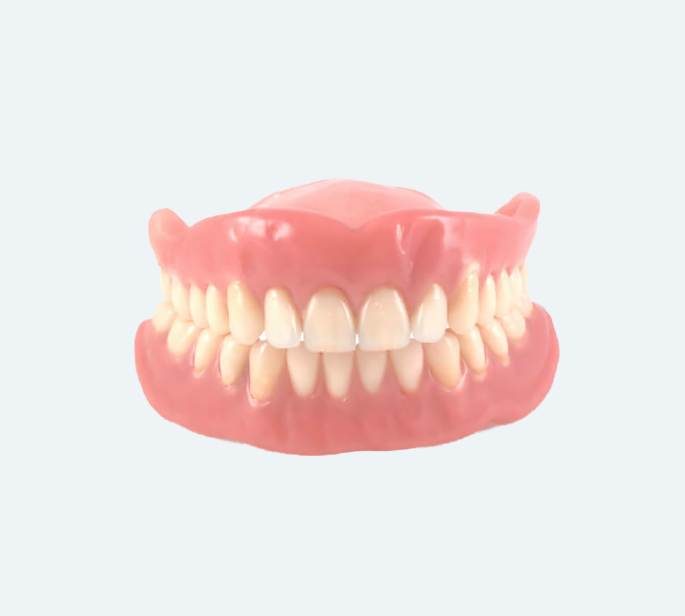 A complete set of top and bottom artificial dentures with white teeth and pink acrylic gums against a plain background.