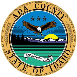 Ada County, Idaho seal: Bald eagle flying over mountains, sun, and green stripes.
