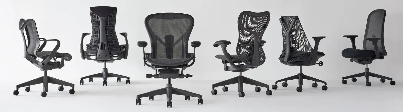 Six black mesh office chairs shown in a row on a white background