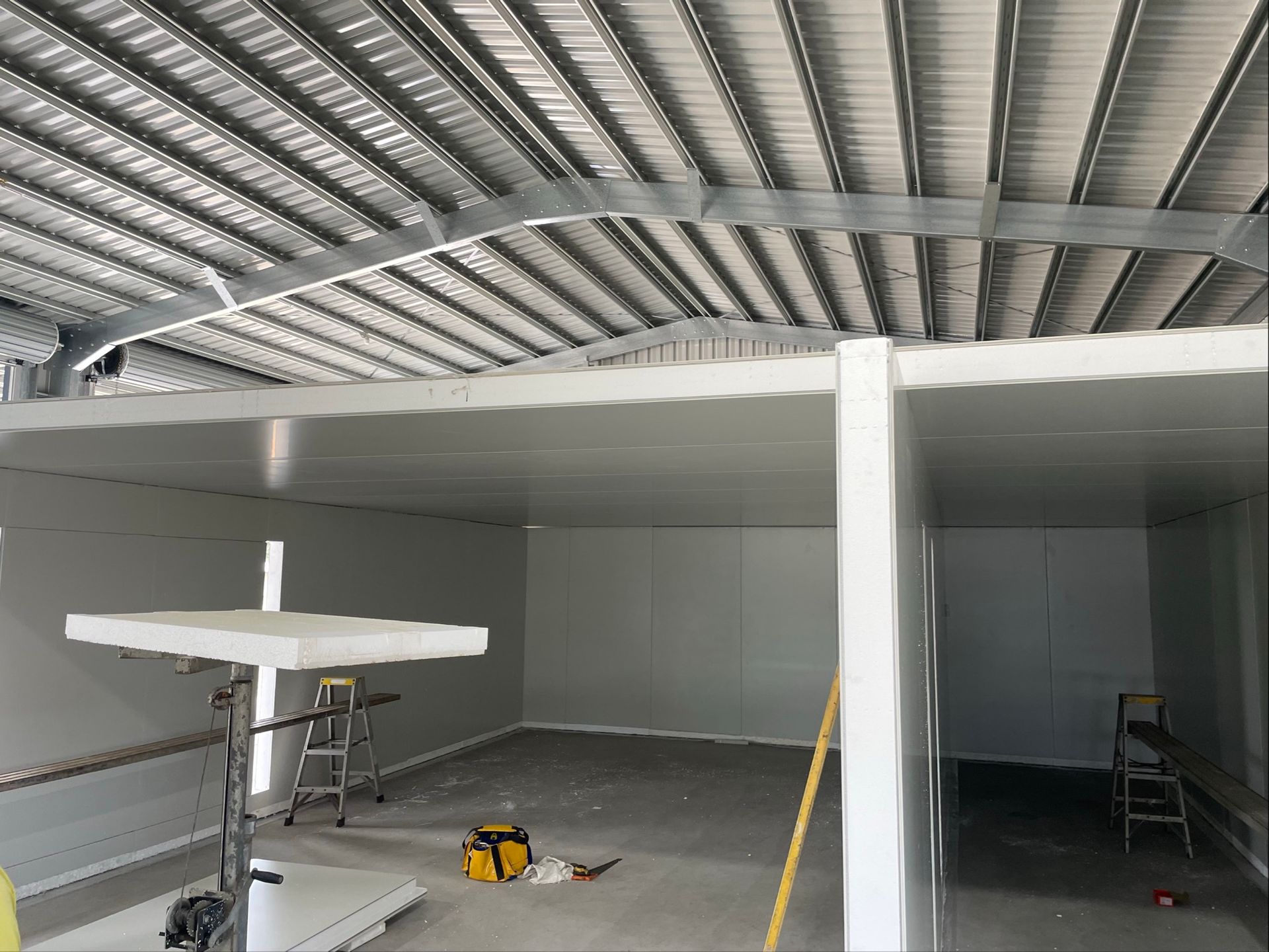 Industrial Warehouse Interior With Corrugated Metal Roof — Les Carman Cooling Solutions in El Arish, QLD