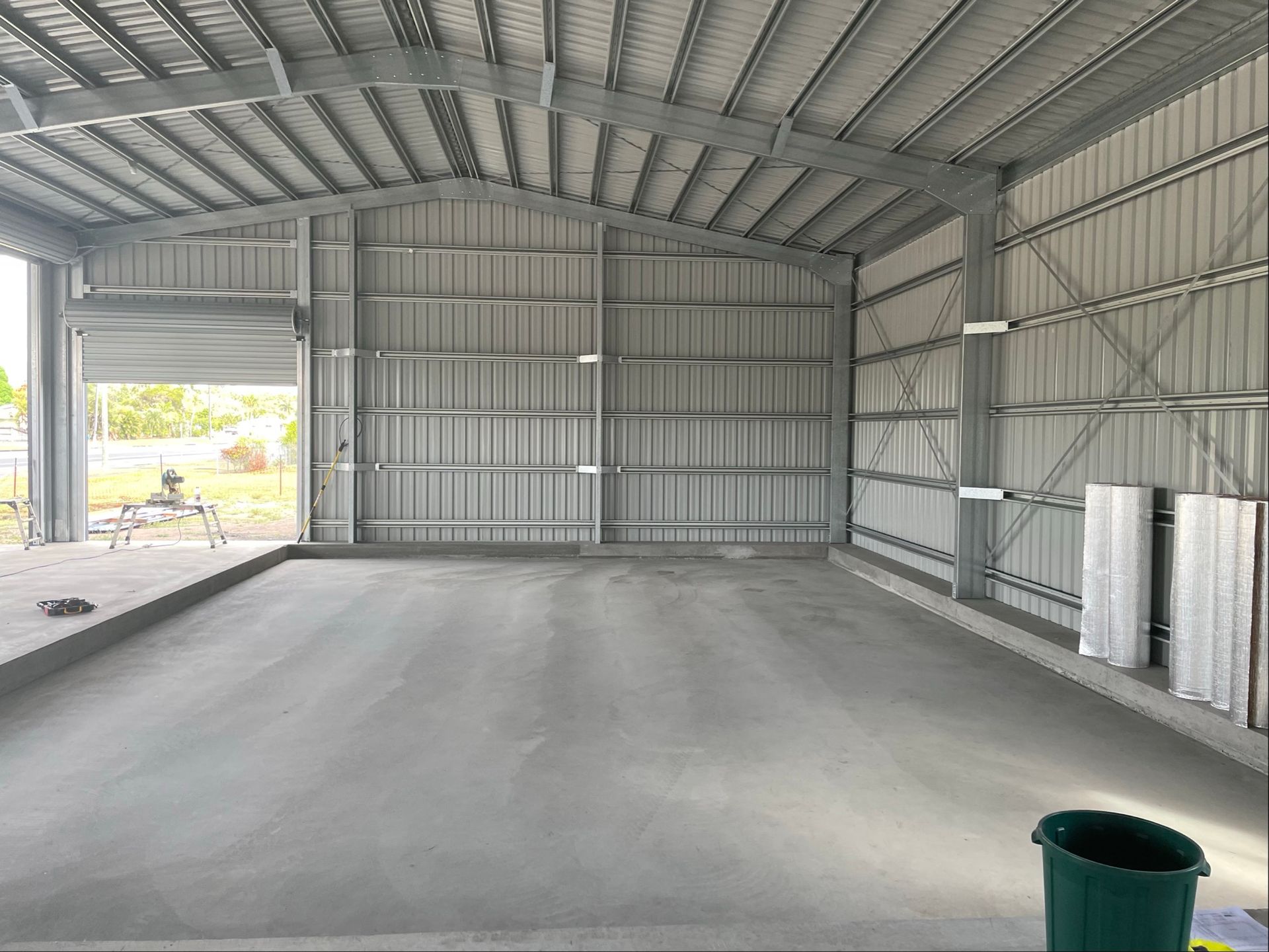 Empty Metal-framed Warehouse Interior With Concrete Floor — Les Carman Cooling Solutions in El Arish, QLD