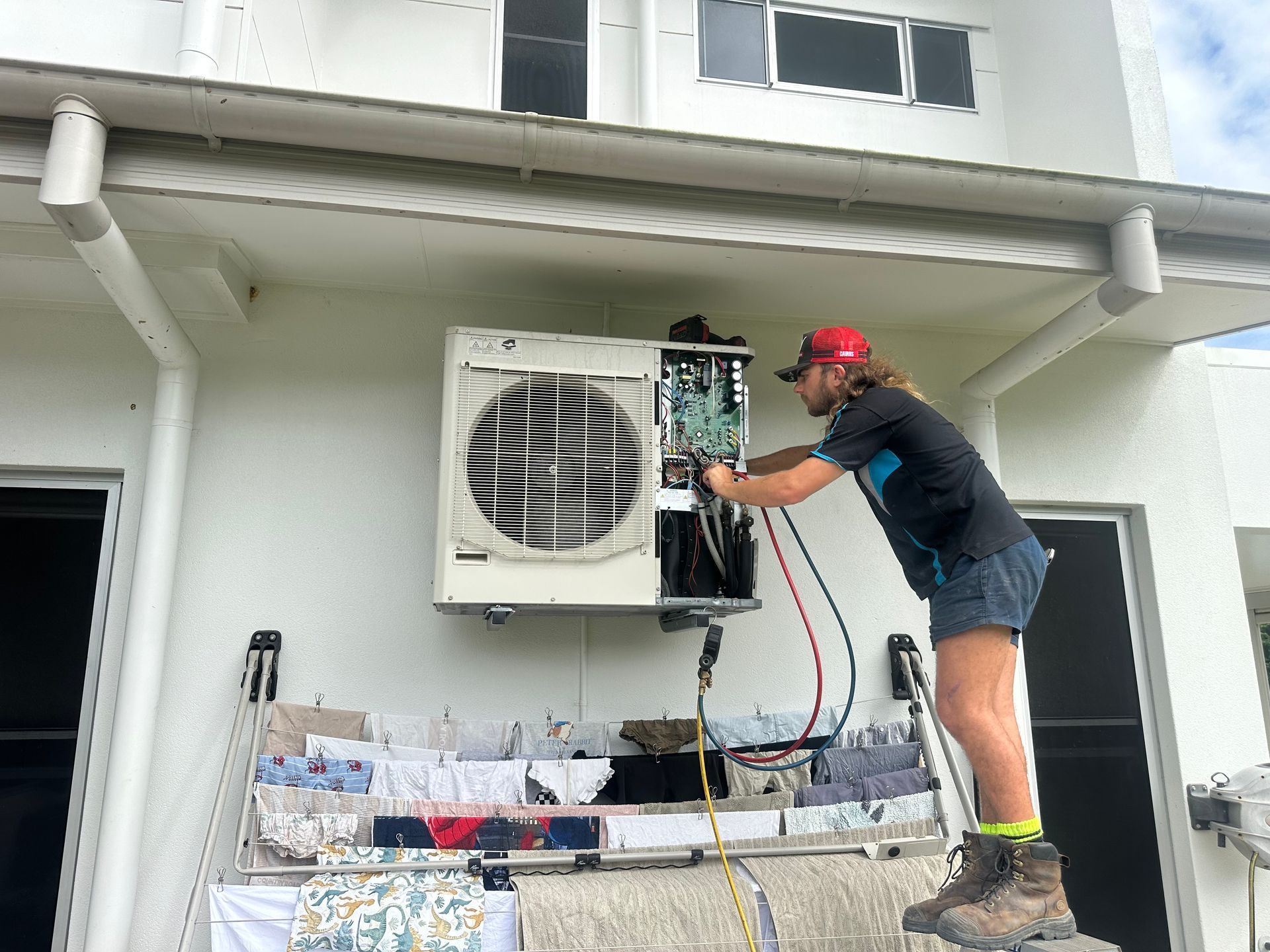 Hand Opening a Stainless Steel Refrigerator — Les Carman Cooling Solutions in El Arish, QLD