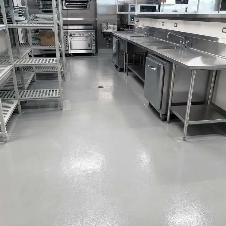Commercial kitchen with stainless steel equipment and a shiny, light gray floor.