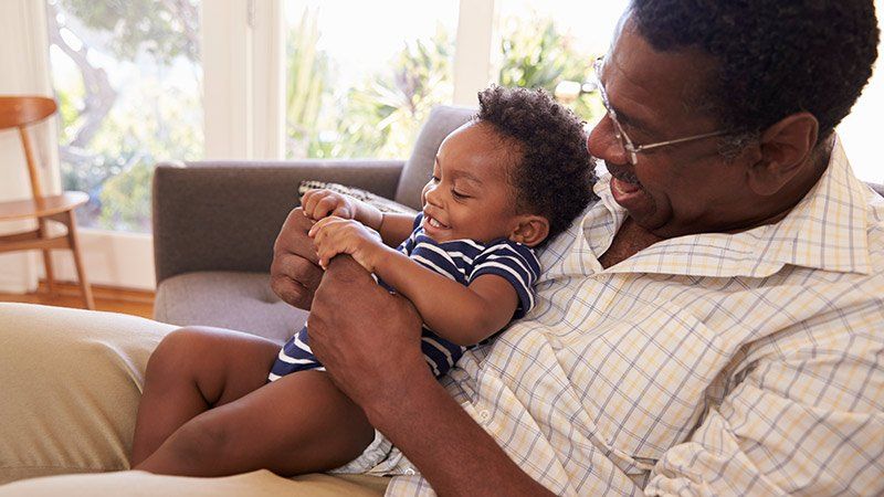 Older man holding baby