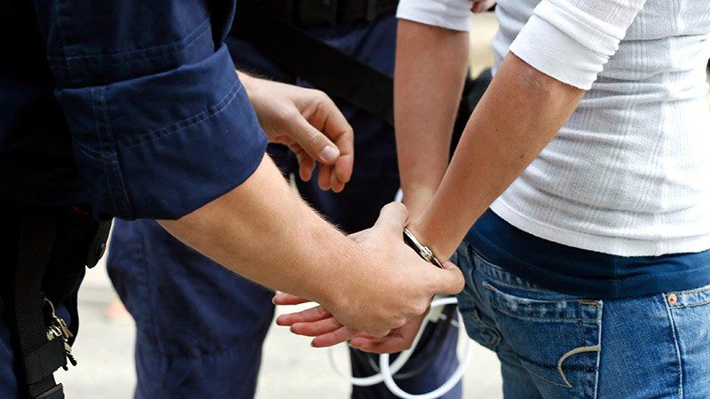young man in handcuffs