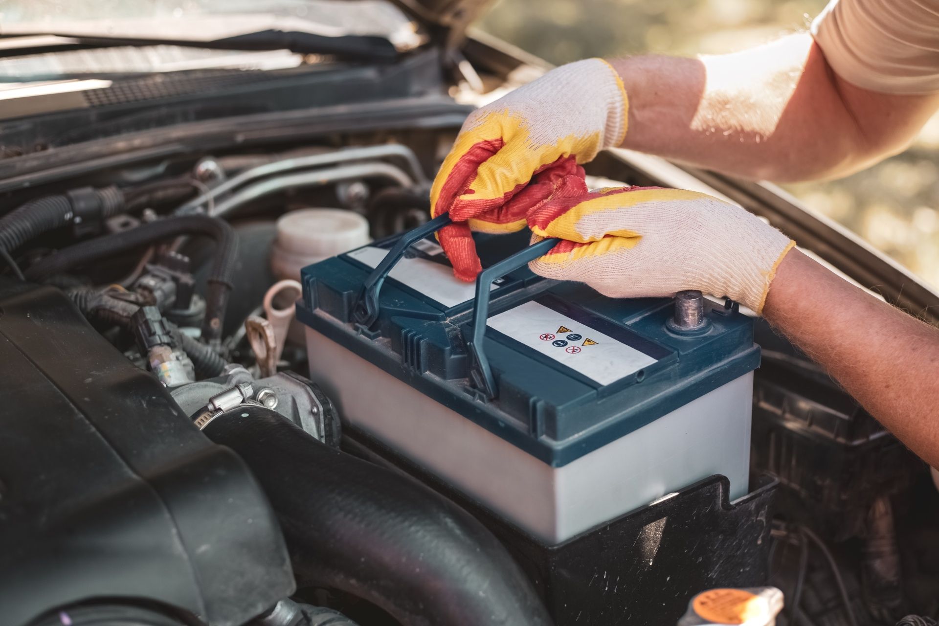 A car battery is being charged with jumper cables.