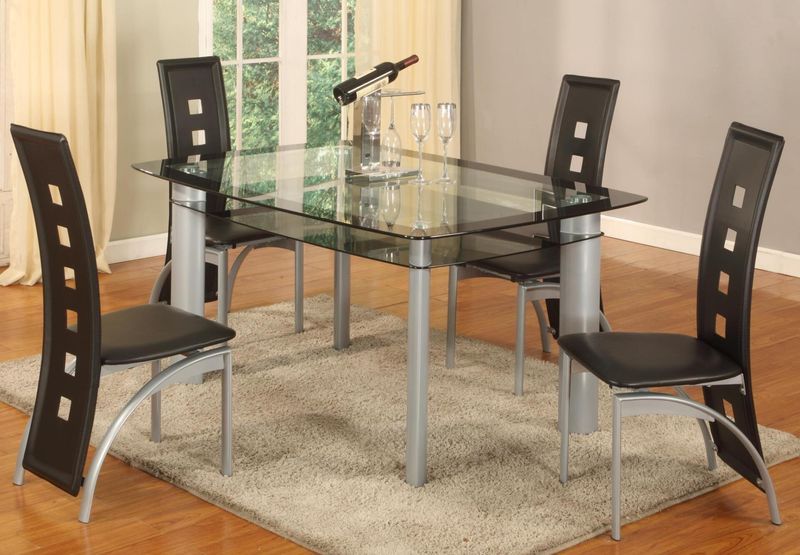 A glass dining table with black chairs in a room