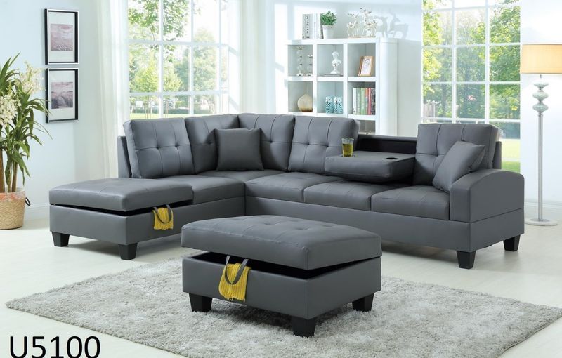 A living room with a grey sectional couch and ottoman