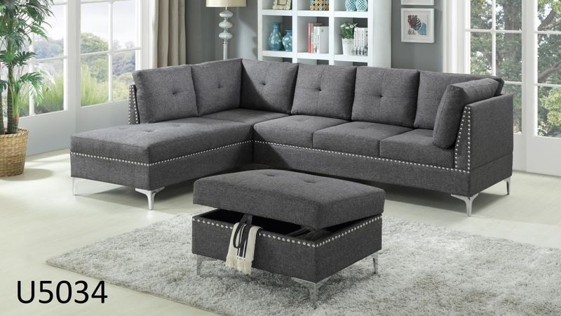 A living room with a sectional couch and an ottoman