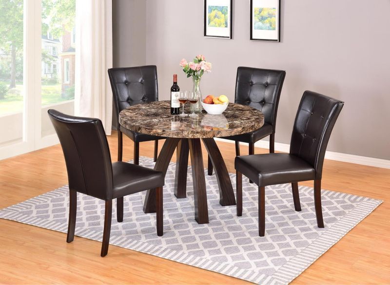 A dining room table and chairs with a bottle of wine on the table.