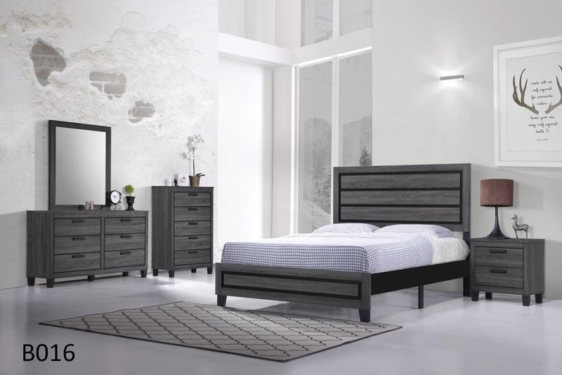 A bedroom with a bed , dresser , nightstand , mirror and rug.