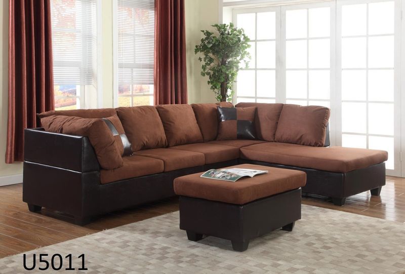 A living room with a brown sectional couch and ottoman