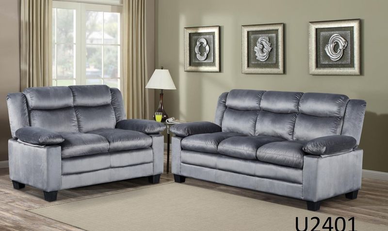 A living room with two grey couches and a lamp.
