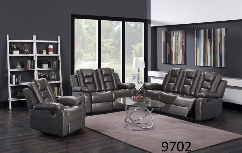 A living room with a couch , two chairs , and a coffee table.
