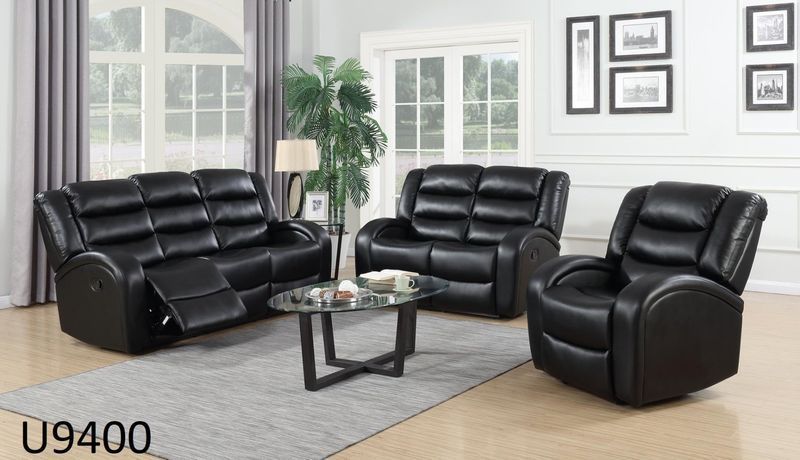 A living room with a couch , two chairs , and a coffee table.