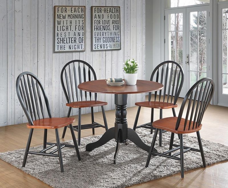 A dining room with a table and chairs and signs on the wall.