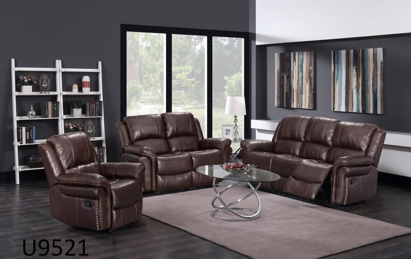A living room with brown leather furniture and a rug