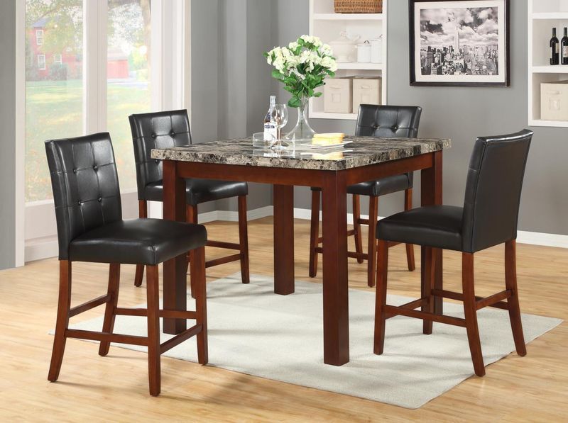 A dining room with a table and chairs and a vase of flowers on the table.