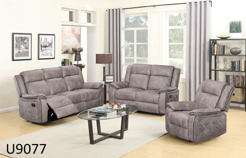 A living room with a couch , chair , and coffee table.