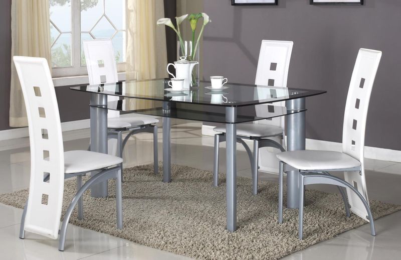 A dining room with a glass table and white chairs
