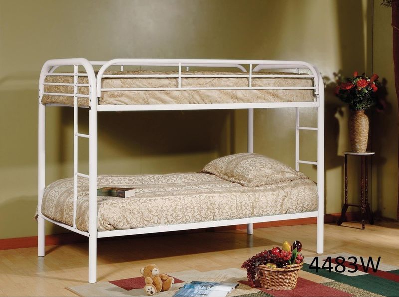 A white bunk bed with a basket of fruit on the floor