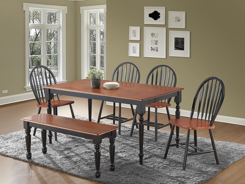A dining room with a table and chairs and a bench.