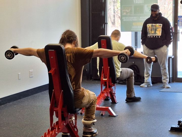 Semi-Private training people doing lateral raises
