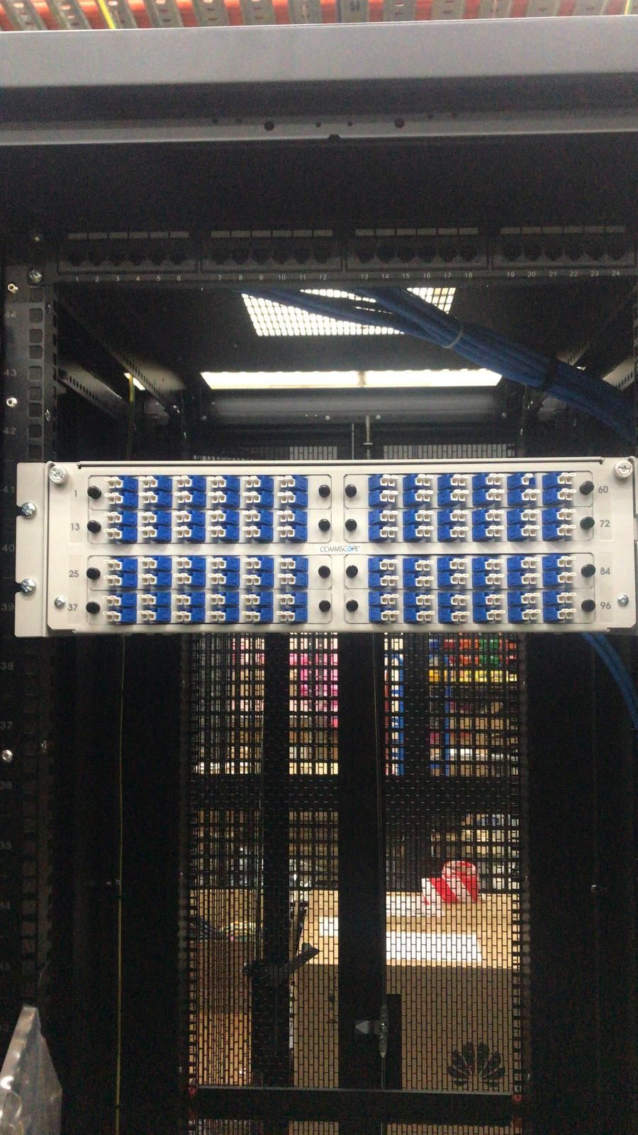 Hand installing a circuit breaker in an electrical panel, wires visible.