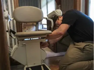 man fixing stairlift