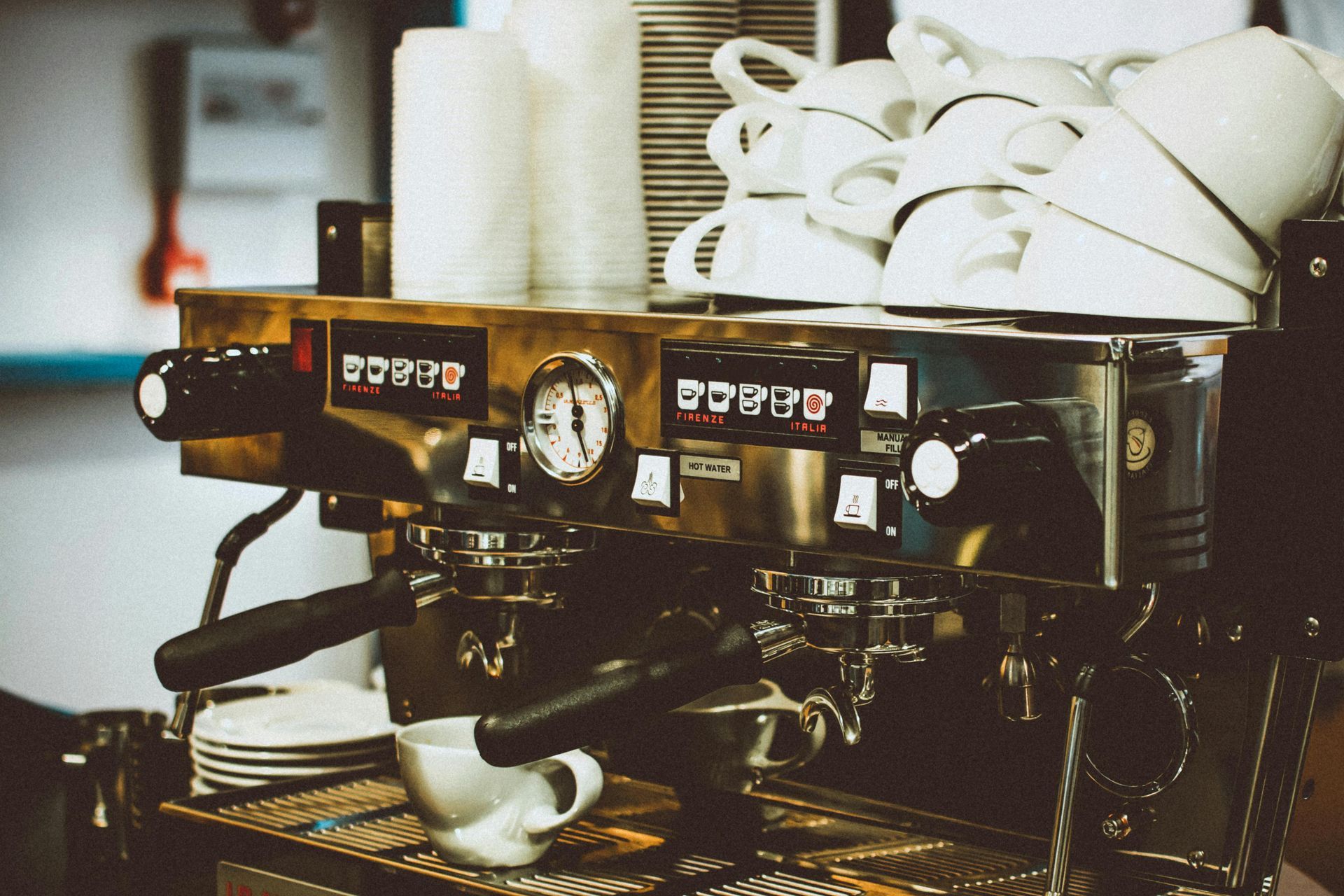 Une machine à café avec une pile de tasses dessus