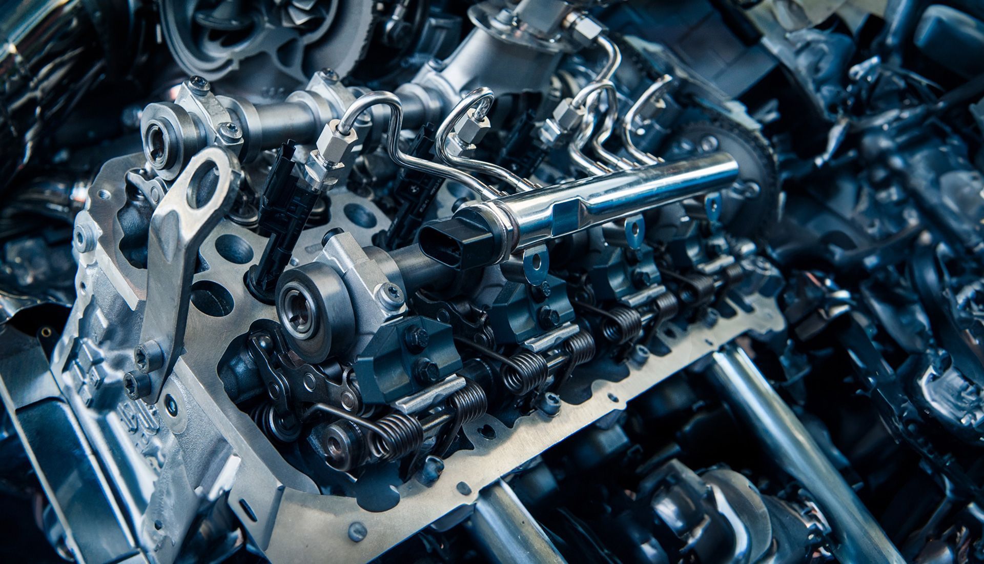 Close-up view of an engine's cylinder head with various mechanical components.