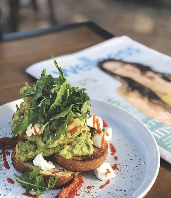 A close up of a plate of food with a magazine in the background