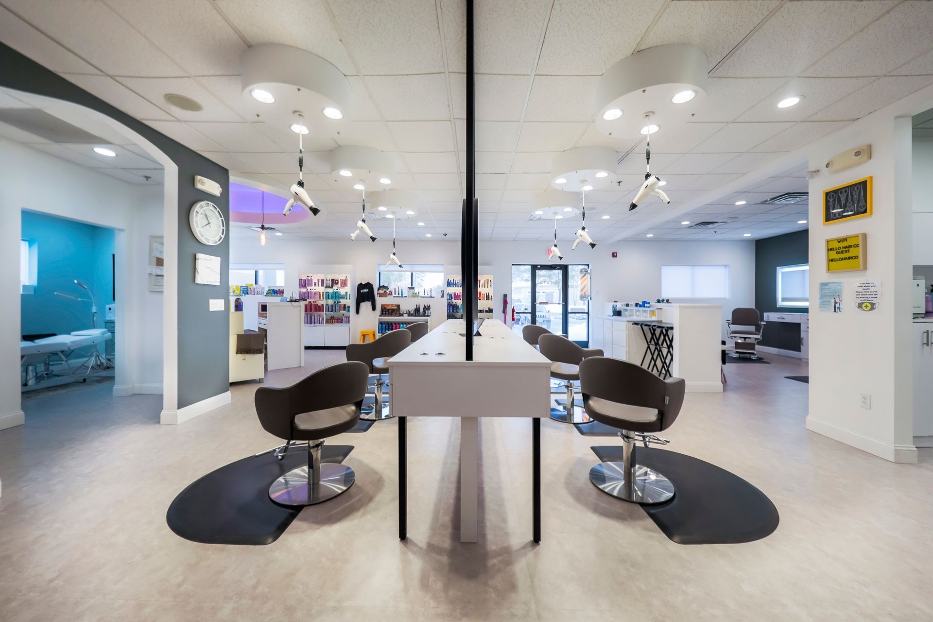 Modern salon interior with chairs and mirrors, illustrating the booth rental vs commission debate in