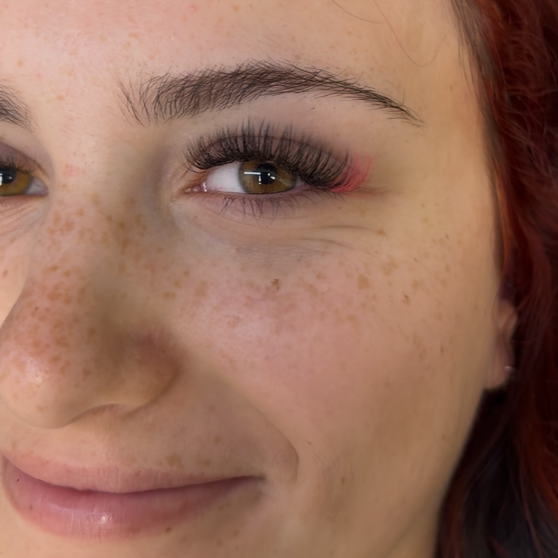 Close-up of client with eyelash extensions and shaped eyebrows at Hello Hair Co