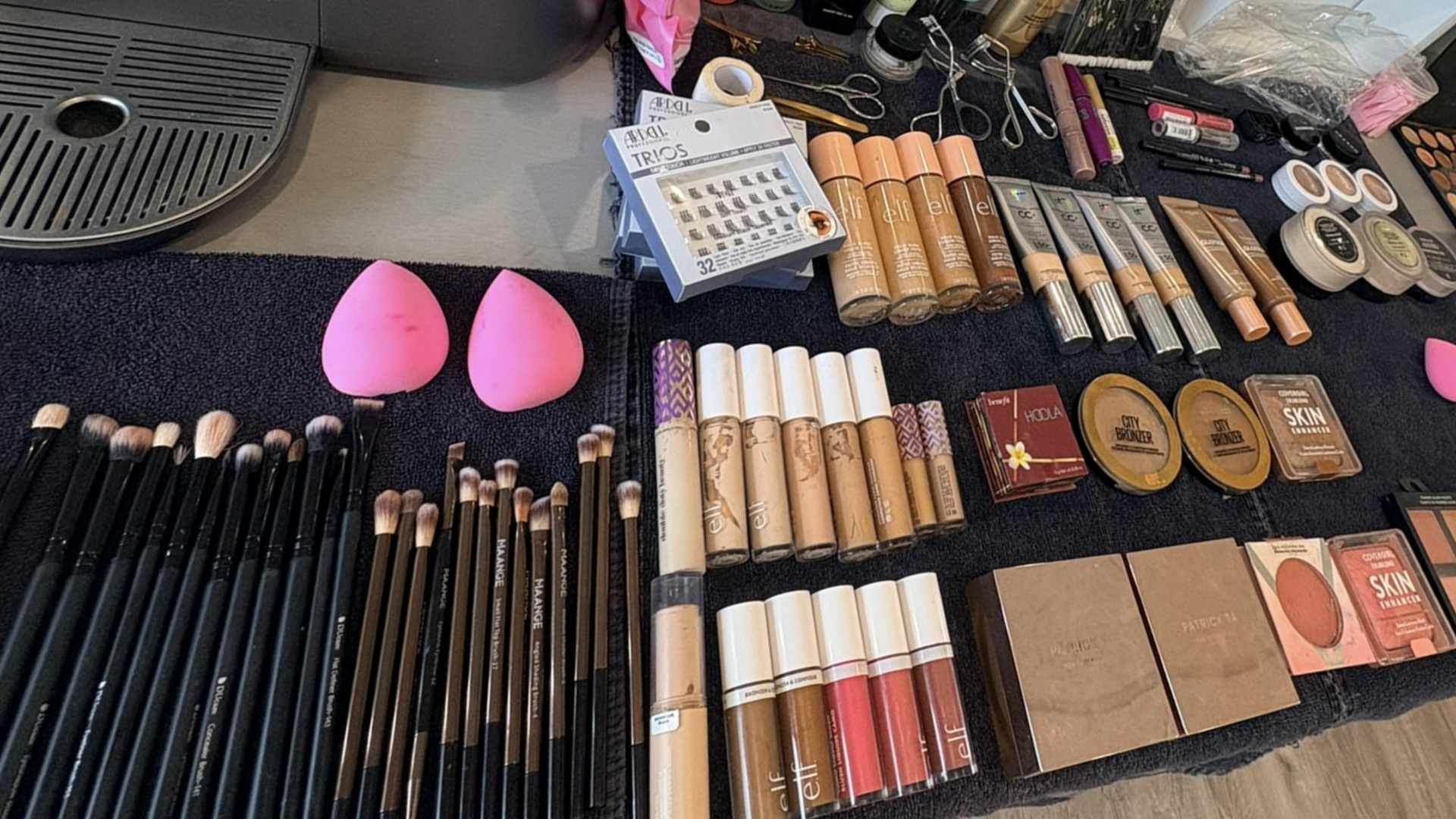 Professional makeup brushes, palettes, and beauty products arranged at Hello Hair Co.