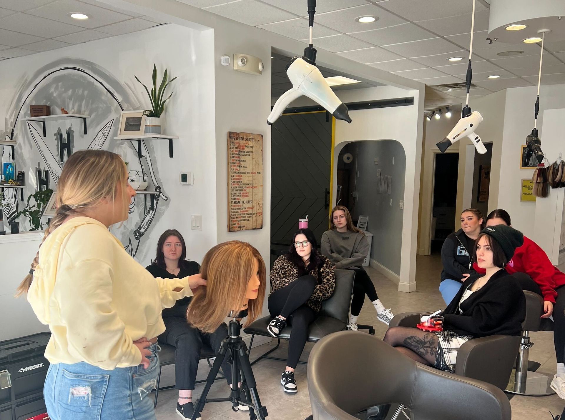 Salon educator teaching stylists, representing education, training, and a strong team