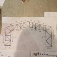 Hand-drawn structural truss diagram on paper, showing a roof span with labeled measurements.