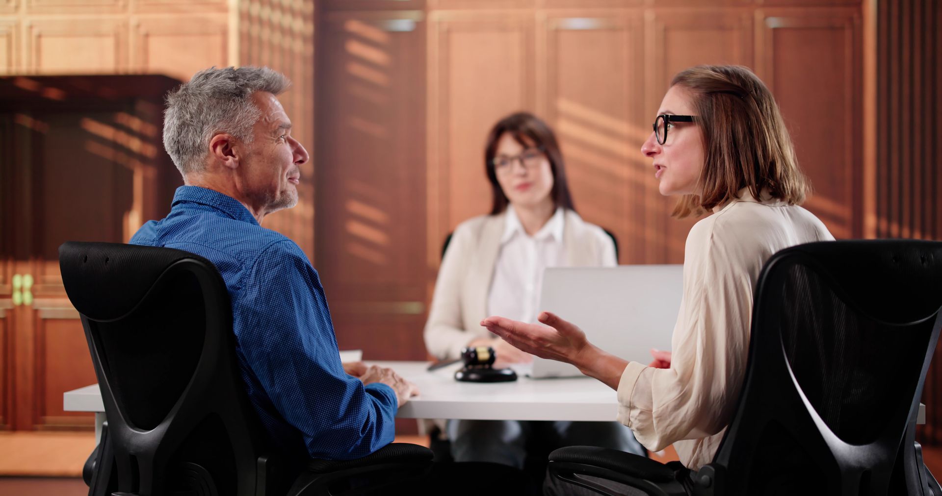 A couple is talking in front of a lawyer.