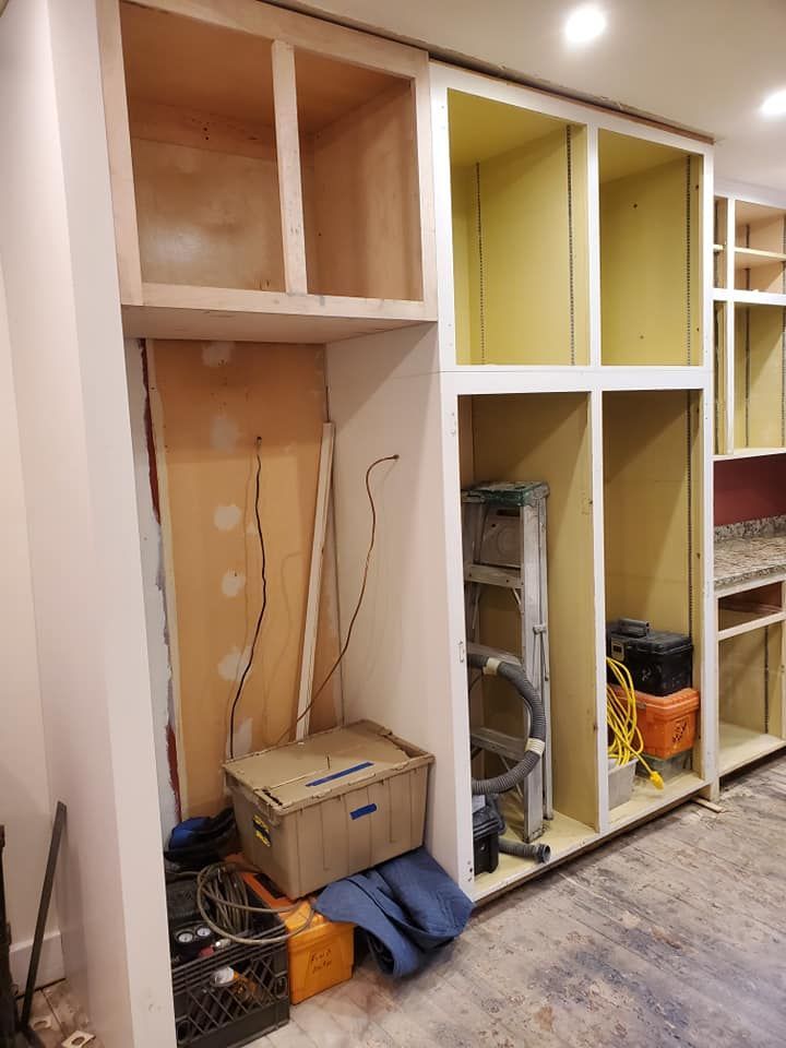 A room with a lot of shelves and a ladder in it.