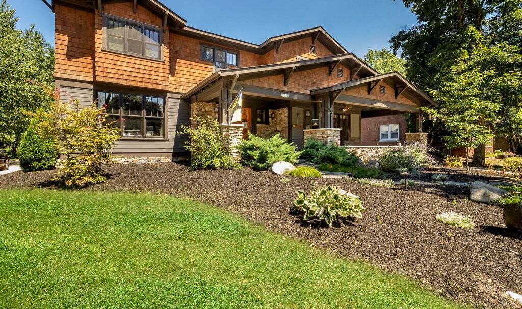 A large house with a lush green lawn in front of it.