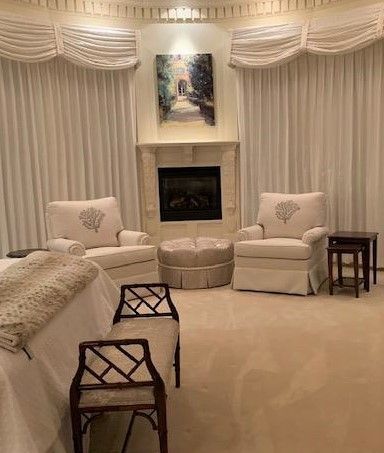 Two arm chairs, an ottoman, and a bench with matching custom upholstery