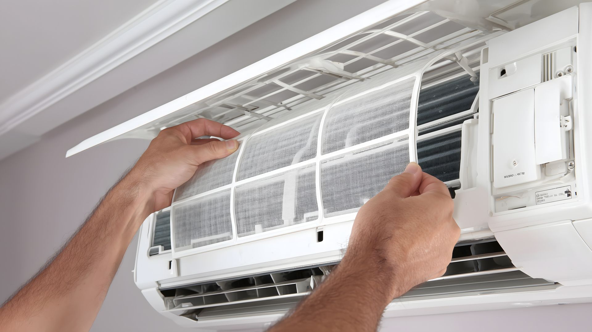 technician cleaning a dirty AC filter during HVAC maintenance