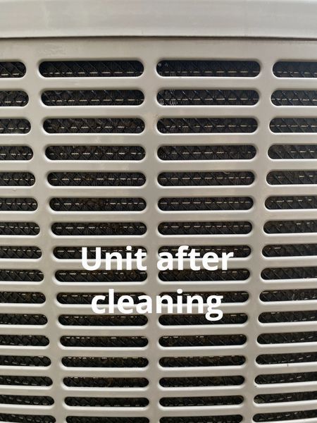 Close-up of a beige vent grille with overlaid text reading “Unit after cleaning”