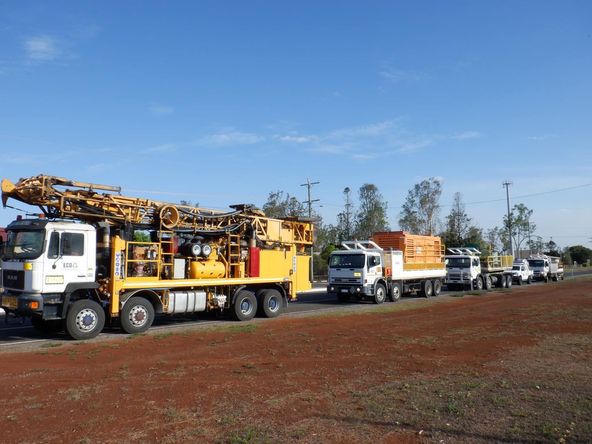 A Row of Trucks Are Parked on the Side of a Dirt Road — Cheyenne Drilling on the Sunshine Coast, QLD