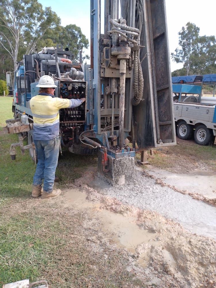 A Man is Standing in Front of a Large Machine — Cheyenne Drilling on the Sunshine Coast, QLD
