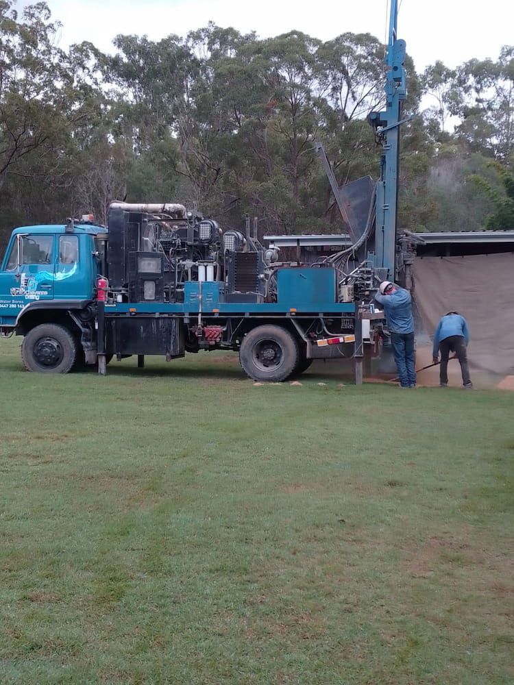 A Blue Truck is Parked in a Grassy Field — Cheyenne Drilling in Kingaroy, QLD